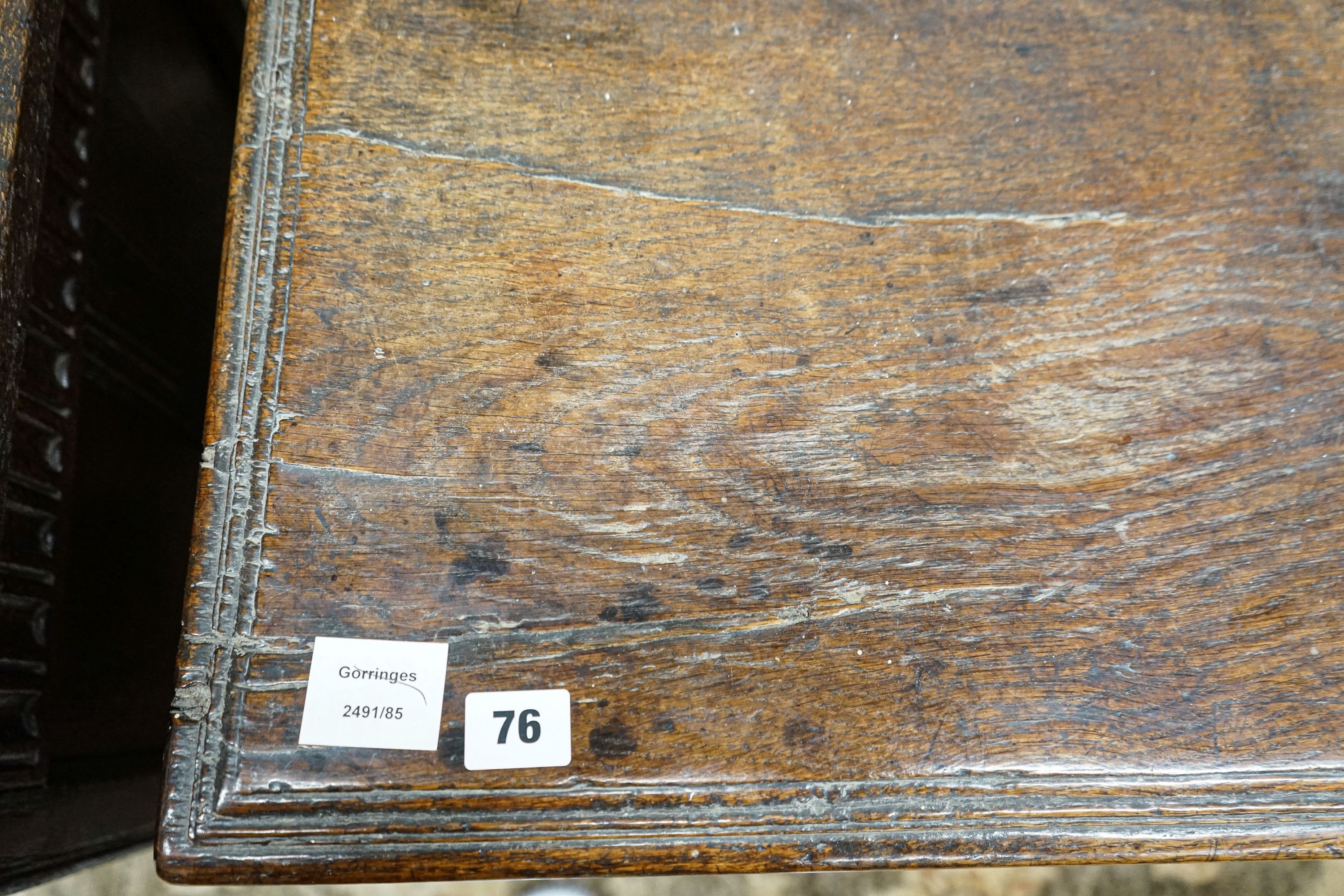 A 17th century oak coffer, with later carved front, length 120cm, depth 56cm, height 69cm
